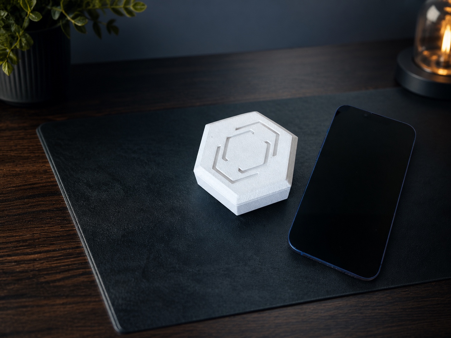 Pestr Alarm beside a phone in a refined walnut workspace