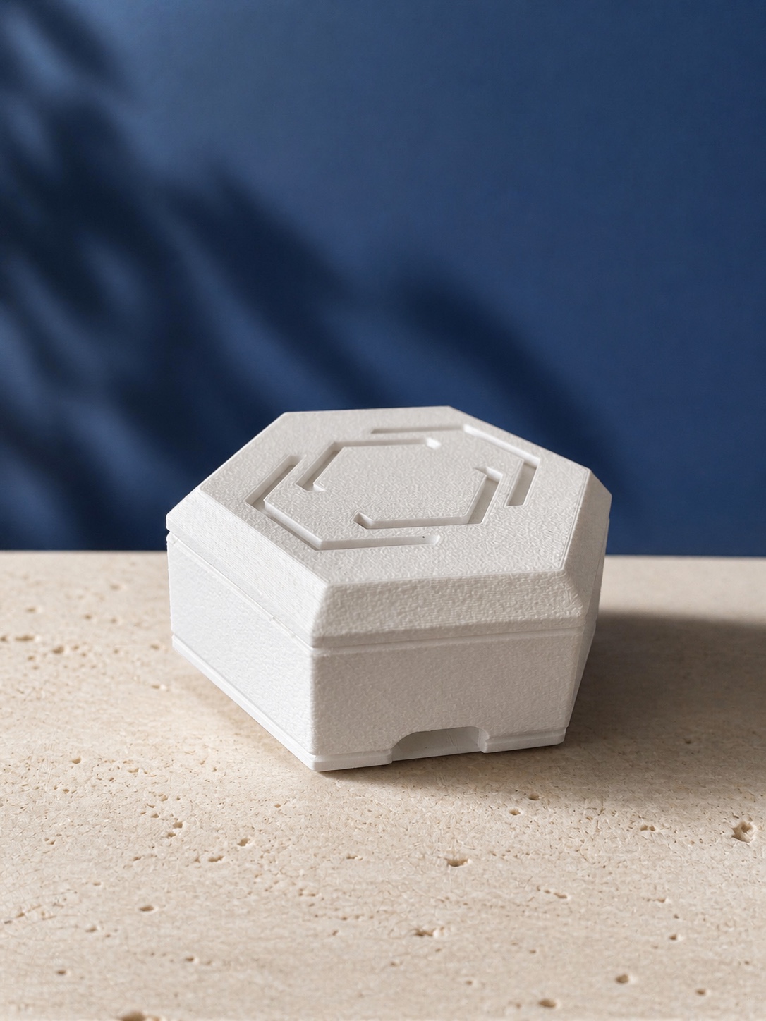 Side view of the Pestr Alarm Hub on a stone surface